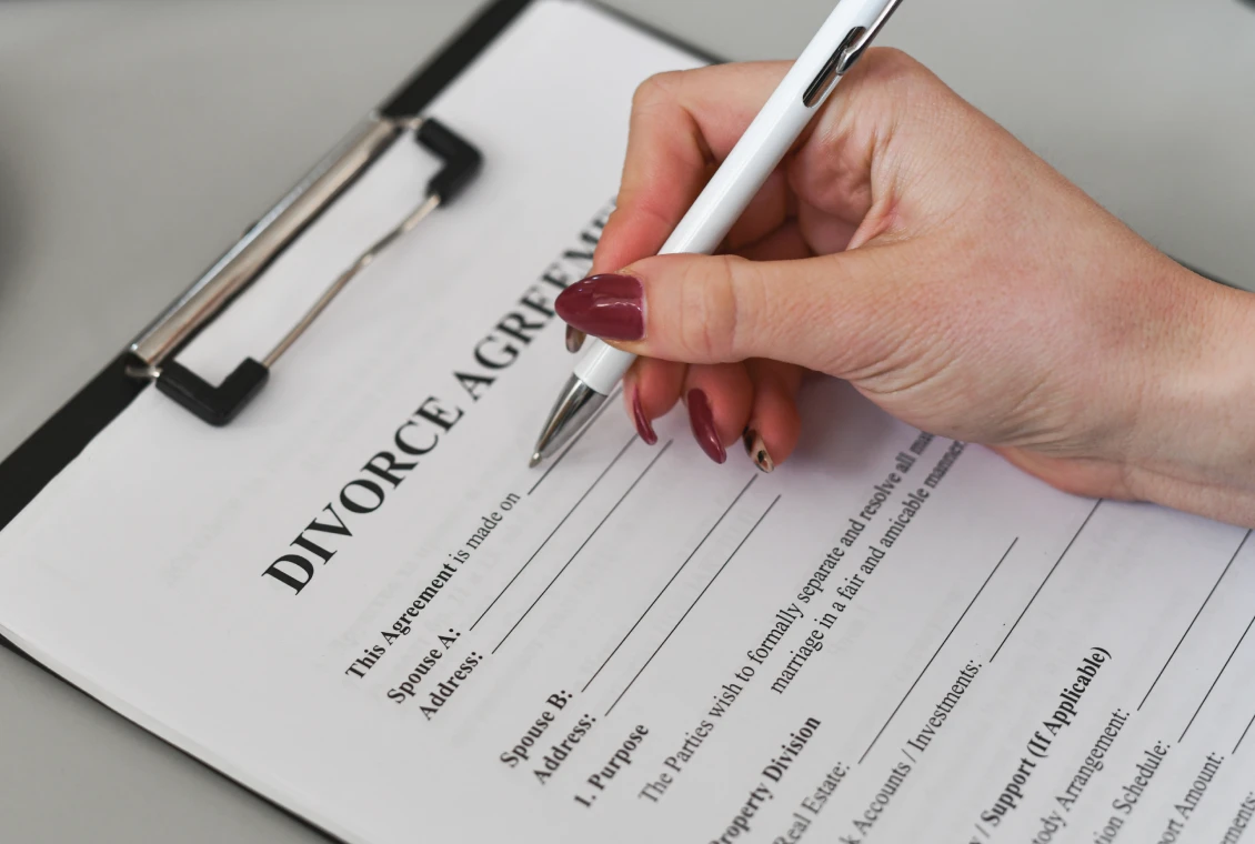 Hand holding pen over document
